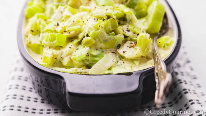 Creamed Leeks in a black dish.