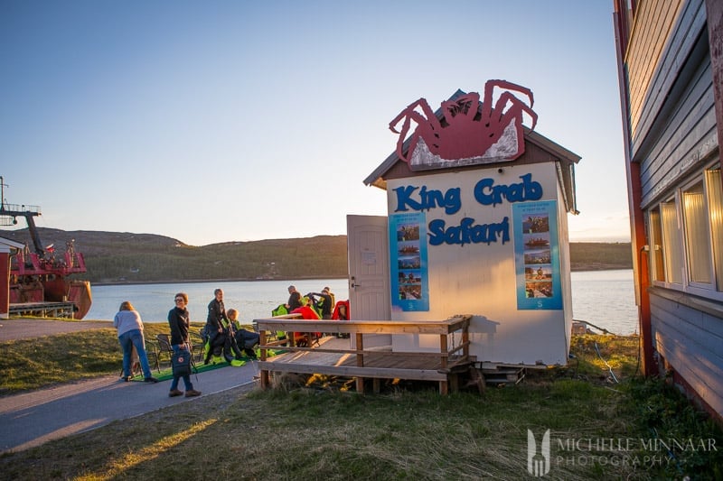 The entrance to King Crab Safari wooden shack with the sign on it